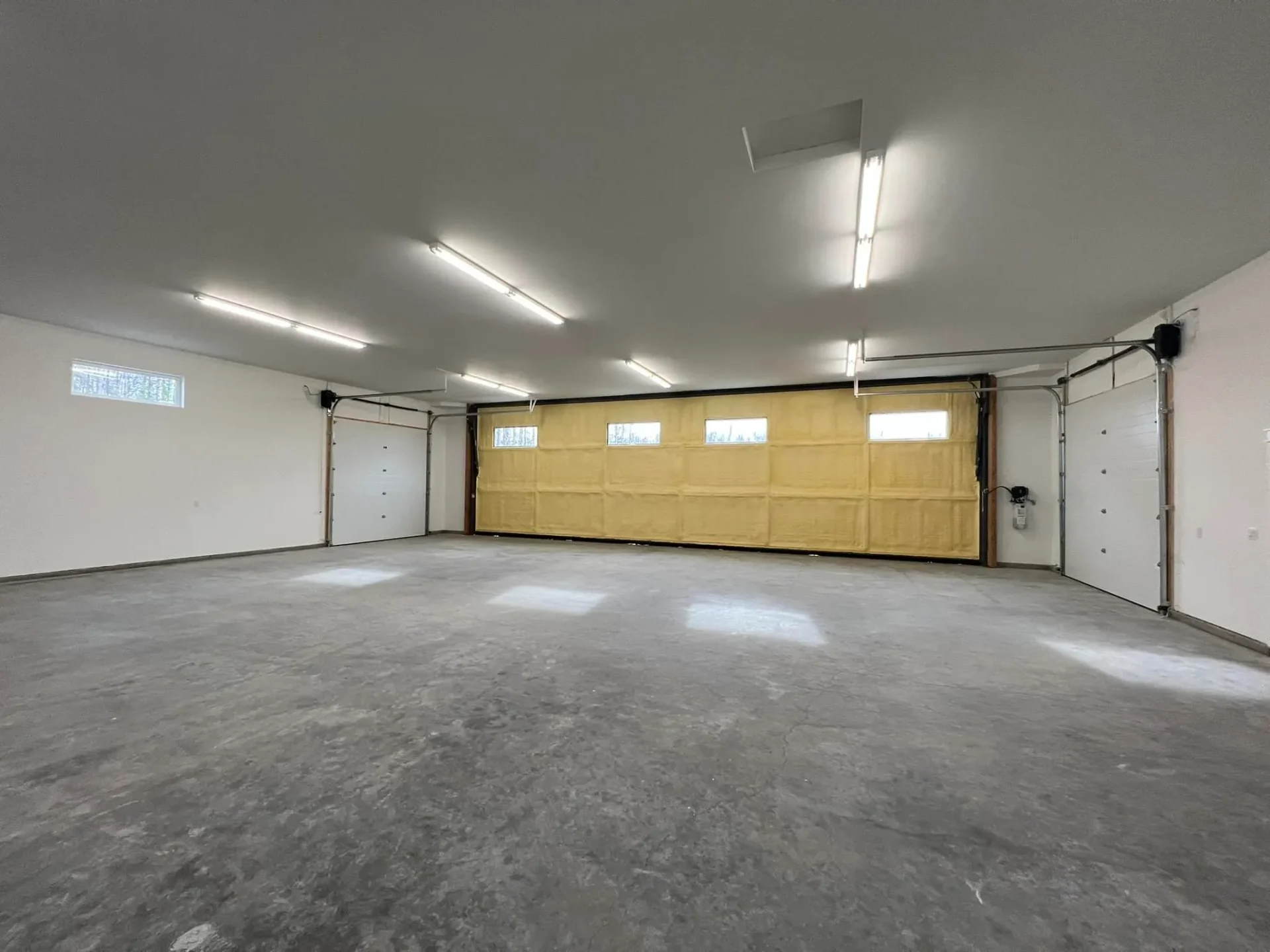 airplane garage with two roll up doors at hangar home in alaska