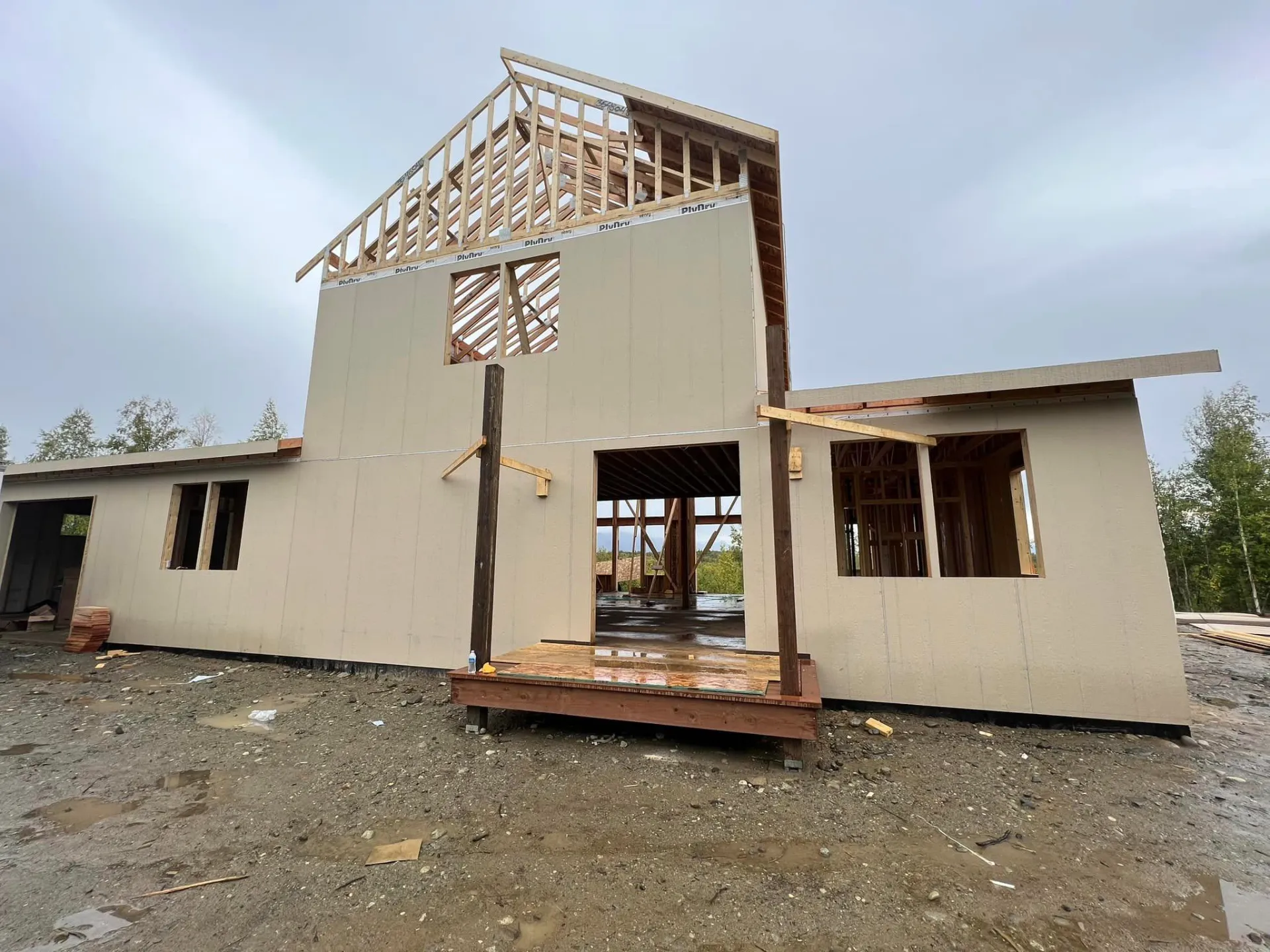 alaskan barndominium being framed up exterior view blacked in