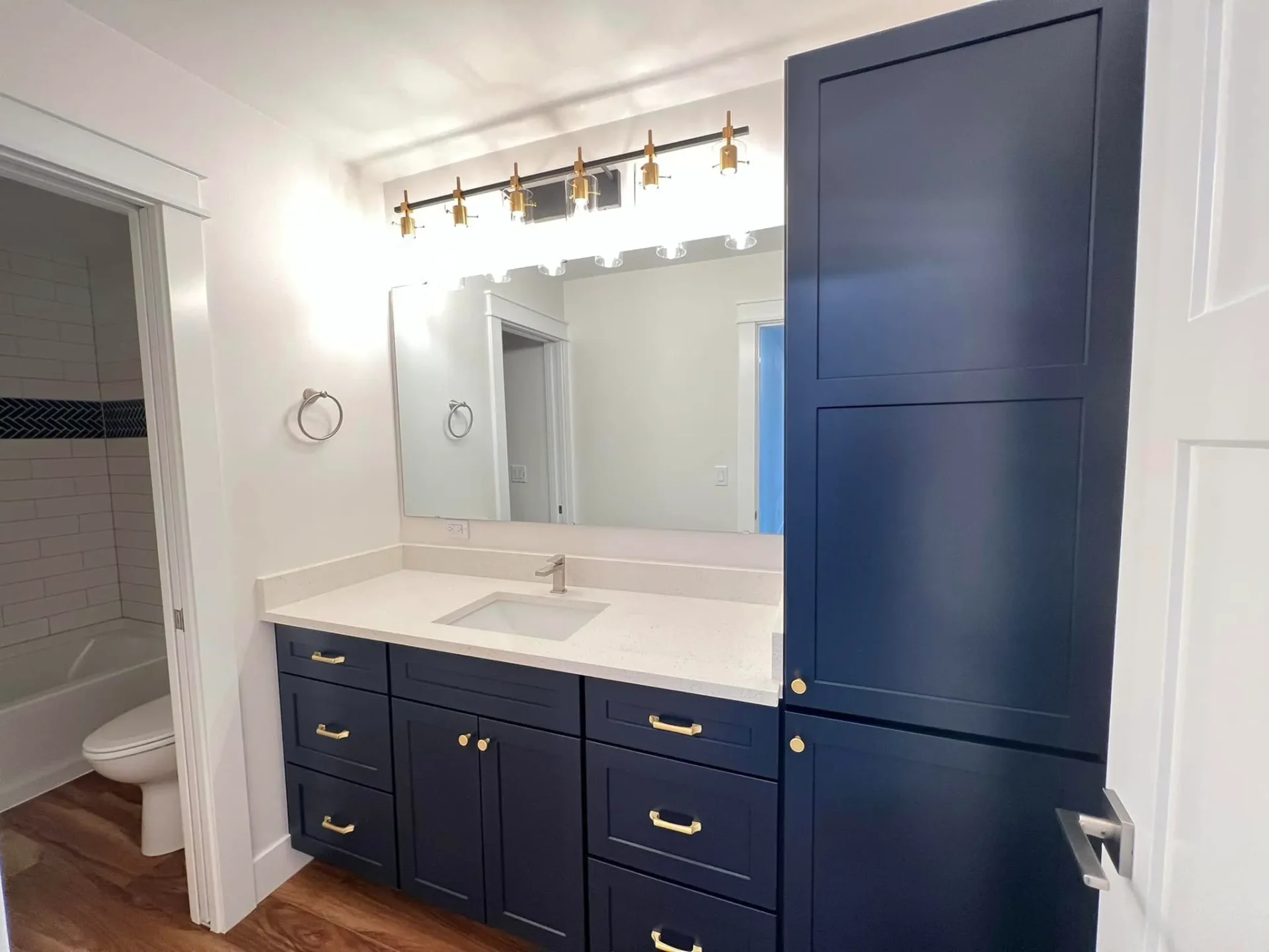 bathroom with blue cabinets at hangar home in alaska