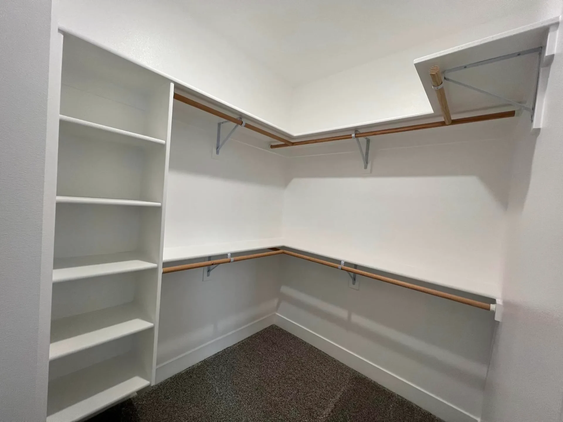 clothes closet with shelves in hangar home in alaska