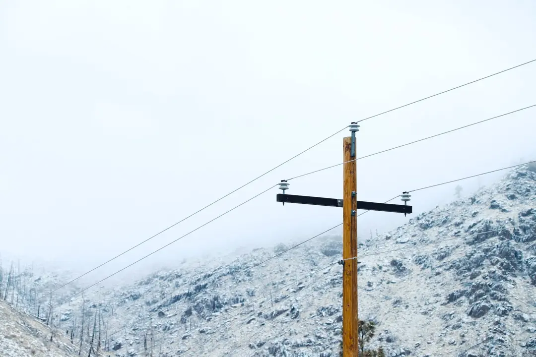 remote utilities lines with snow covered alaska mountains in background